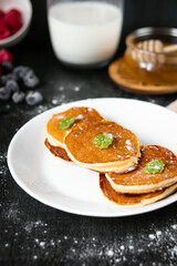 delicious pancakes with berries on a dark background. morning. breakfast