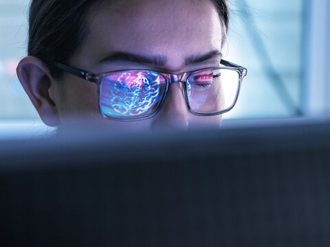 Doctor researching on brain MRI and using computer with AI technology