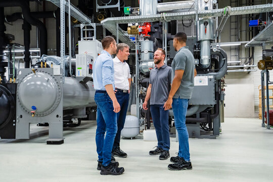 Businessmen and employees having a meeting in factory