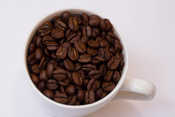 Fototapeta premium Cup of coffee on white . beverage drink concept. white cup of coffee with green beans stands on a white . a man standing on a white with a cup of coffee lifestyle and beans.