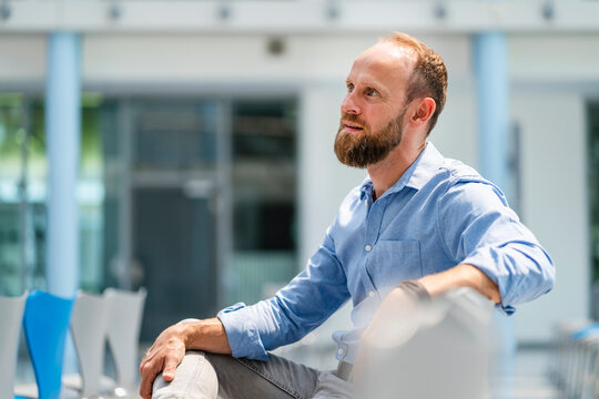 Confident businessman sitting in company auditory