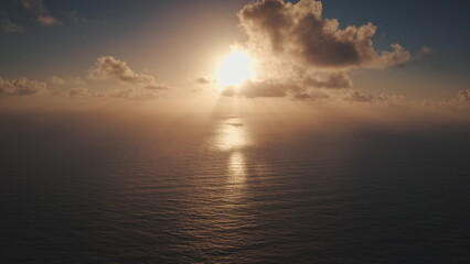 Breathtaking sunset over the pacific ocean, with golden light reflecting on tranquil waters and...