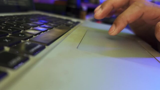 Man's finger pressing the spacebar and scrolling the touchpad of a laptop. Close-up of hands Typing using touch screen on laptop