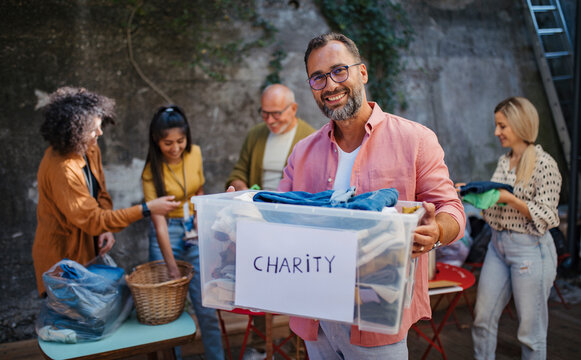 People donating and collecting clothes for charity