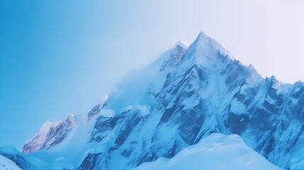 Fototapeta premium A Snowy Mountain Peak Under a Blue Sky