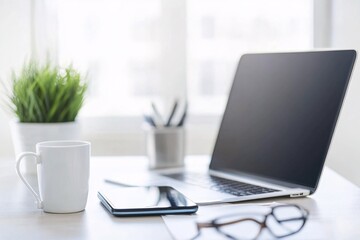 Fototapeta premium Minimalist Workspace: Laptop, Coffee Mug, and Tablet on a White Desk