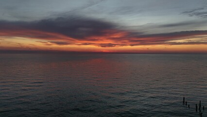 Scenic sunset over calm ocean waters with vibrant orange hues in the sky