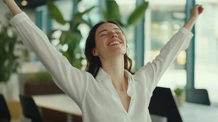 Fototapeta premium Office worker taking a break to do stretches in a modern office setting, promoting work-life balance and physical well-being in the workplace.