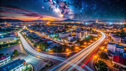 Obraz premium Captivating Time Lapse of City Lights and Traffic with Stars in Orbit at Khao Praya Dern Thong Viewpoint, Lopburi, Thailand - High ISO and Long Exposure Effects