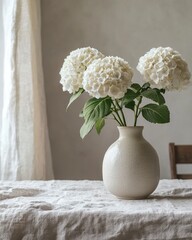 white hydrangea in vase near window on the table with linen tablecloth, Scandinavian style. natural elegance, still life arrangement.