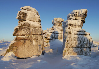 Snow covered rock formations on a mountain ridge in winter
