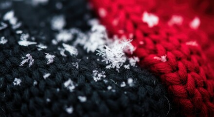 Close-up of snowflakes on red and black knitted fabric