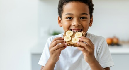 Smiling child enjoying healthy snack with banana and whole grain bread in kitchen