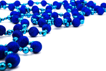Necklace garland for holiday decoration made of beads in the form of round shiny balls isolated on white background.