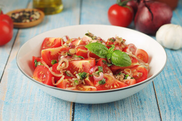 A bowl with Romanian tomato salad de Rosii