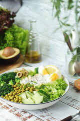 A bowl with a salad made of green vegetables