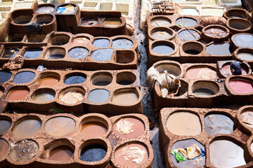 People works in the Shuara leather dyeing factory. Traditional Moroccan craft.