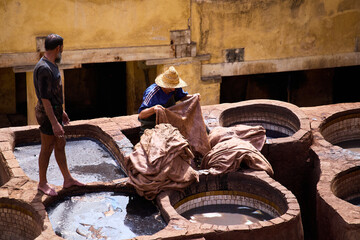 People works in the Shuara leather dyeing factory. Traditional Moroccan craft.