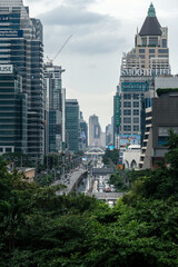 Bangkok city viewed from green space, Sathon Road, lined with skyscrapers, corporate offices, banking and finance related