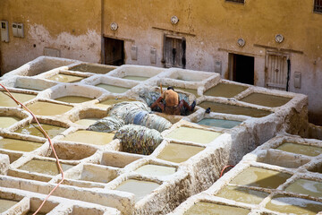 People works in the Shuara leather dyeing factory. Traditional Moroccan craft.