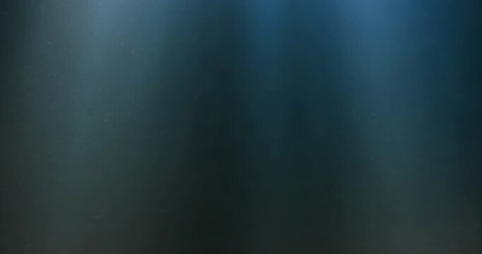 light rays, seamless loop of deep blue ocean waves from underwater background