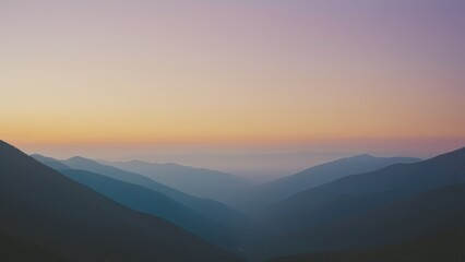 Obraz premium Breathtaking mountain landscape with soft light illuminating rolling hills and peaks, perfect for nature and travel themes