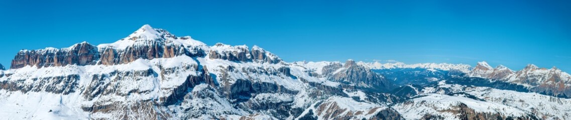 Dolomites in Italy. Wide panorama with Sella group mountain massif in winter. Famous ski and snowboard region with popular resorts around and famous Sella Ronda ski trail carousel around Sella