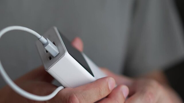 A man uses a power bank to charge a gadget.
Phone charging station.
Partial charging for the phone.
A discharged phone is on charge.
The battery is dead