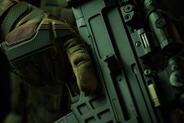 Close-Up of Soldier&rsquo;s Hands Holding Tactical Rifle in Camouflage Gloves