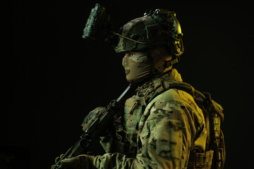 Profile of Soldier in Tactical Gear with Night Vision and Rifle