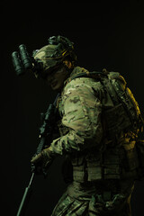 Side Profile of Soldier in Tactical Gear with Rifle and Night Vision Goggles