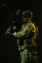 Side Profile of Soldier in Tactical Gear Loading Rifle Magazine