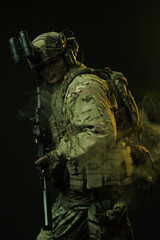 Soldier in Tactical Gear with Night Vision Goggles Amidst Smoke