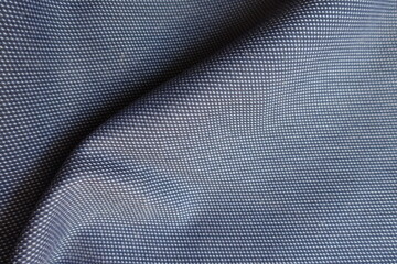 Soft fold on striped cotton fabric in shades of blue
