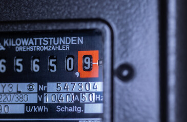 Close-up power consumption, analog electricity meter in the basement. Measuring used electricity in...