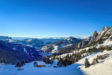 Scenic view of Val Gardena, South Tyrol, Italy against blue sky in winter