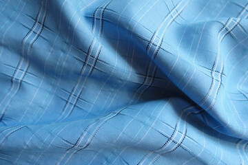 Soft folds on bright sky blue checkered modal fabric