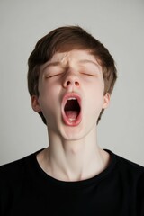 Young man in black shirt with mouth open.