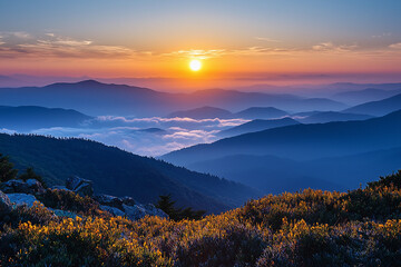 Obraz premium Beautiful sunset over misty mountains with vibrant colors