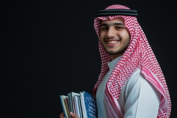 Fototapeta premium Smiling Arab Man in Traditional Clothing Holding Books
