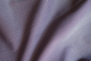 purple and white striped cotton fabric in soft folds