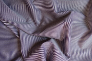 Rumpled purple and white striped cotton fabric