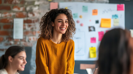A businesswoman discussing project progress with her team, using a digital display to highlight key milestones 