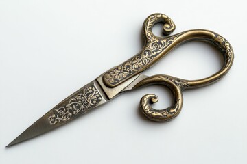 Ornate gold scissors on a white surface.
