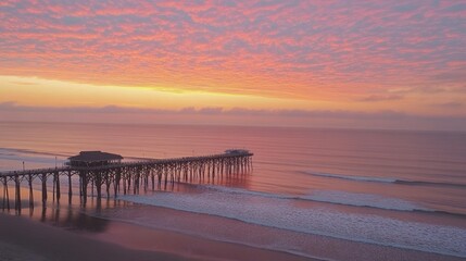 Fototapeta premium A serene sunset over a pier, reflecting vibrant colors on calm waters.