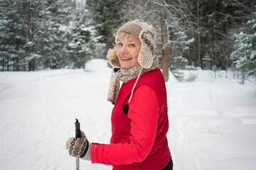 senior active woman outdoots portrarit - skiing in forest
