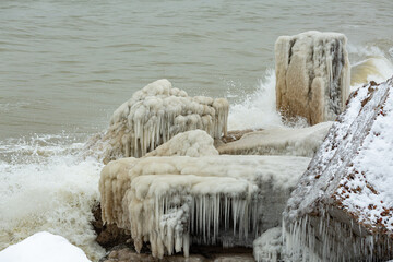 Icy building constructions in sea in winter