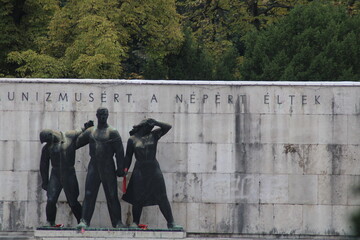 Monument commemorating workers and their struggles in Budapest, surrounded by trees and a serene...
