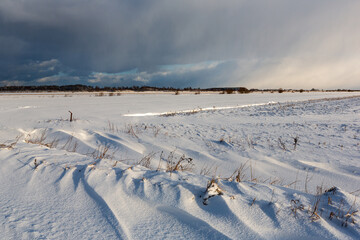 Obraz premium Cloudscape Snowy winter day in countryside 