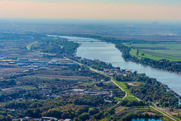 Aerial view of valley with farm fields, pond and Danube river. High quality photo